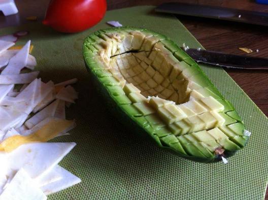 En avocado skiver til små terninger med en sløv kniv, så huden forbliver intakt